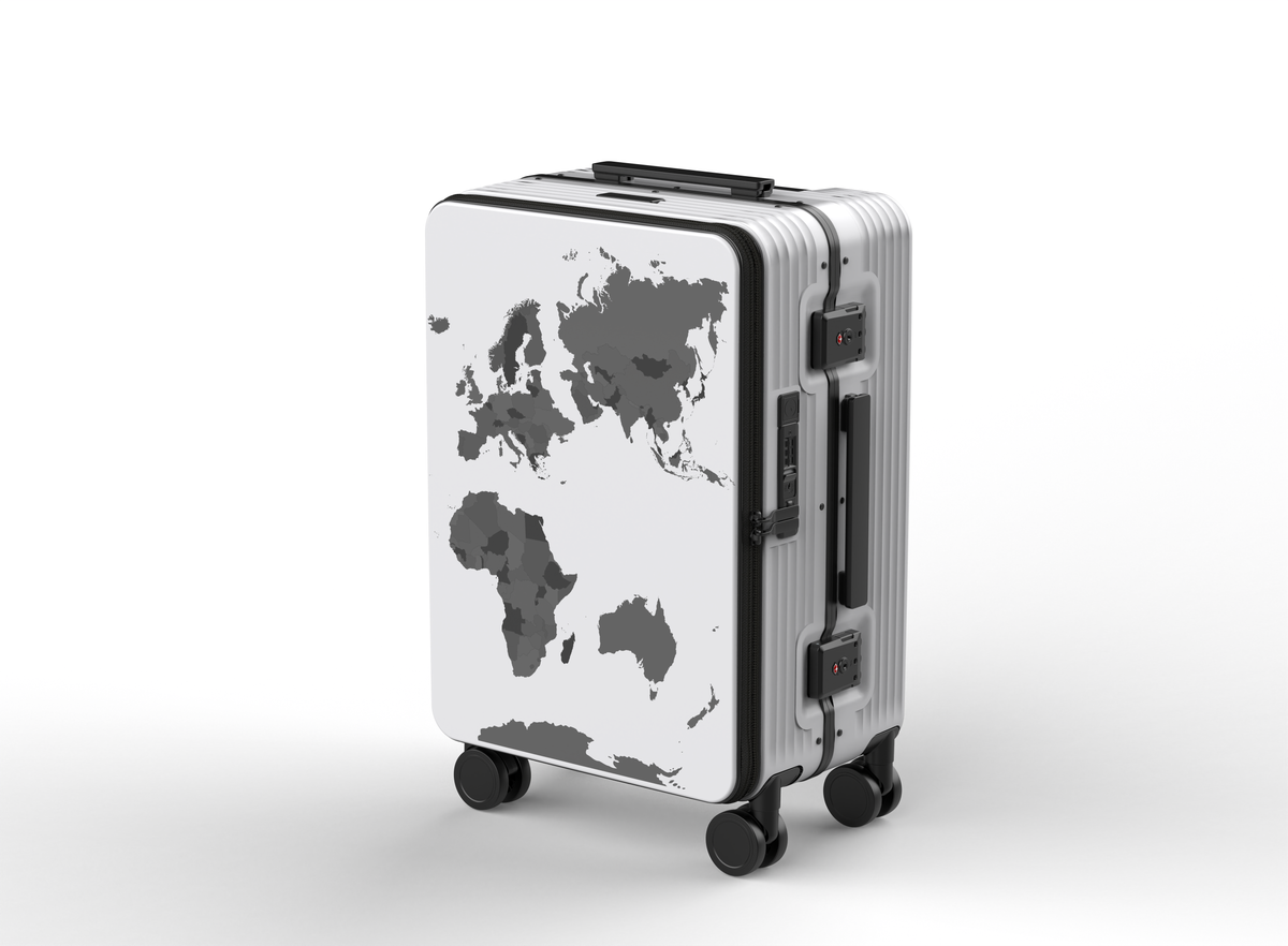 A TRVLD carry-on suitcase with a built-in map decal, predominantly white with black accents, and silver aluminum frame. World map luggage with decals and a water bottle holder