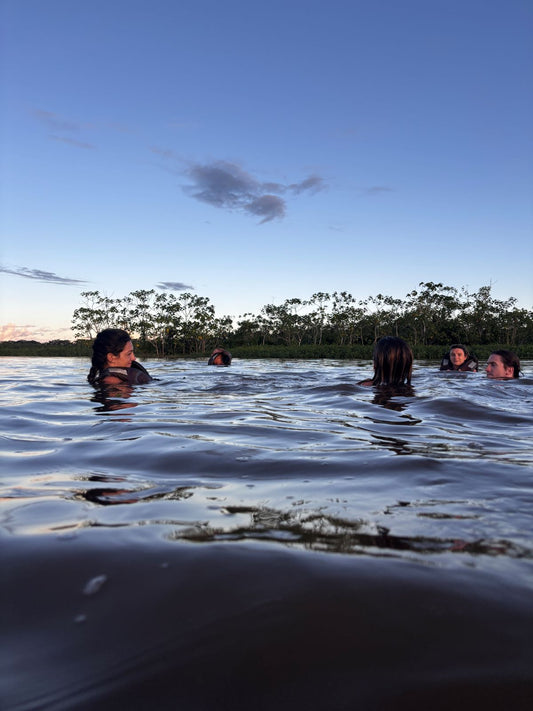 people swimming in the Amazon river