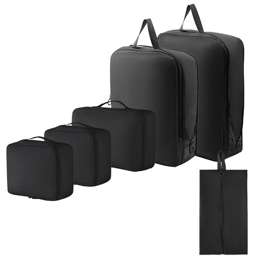 Set of black packing and compression cubes in various sizes on a white background